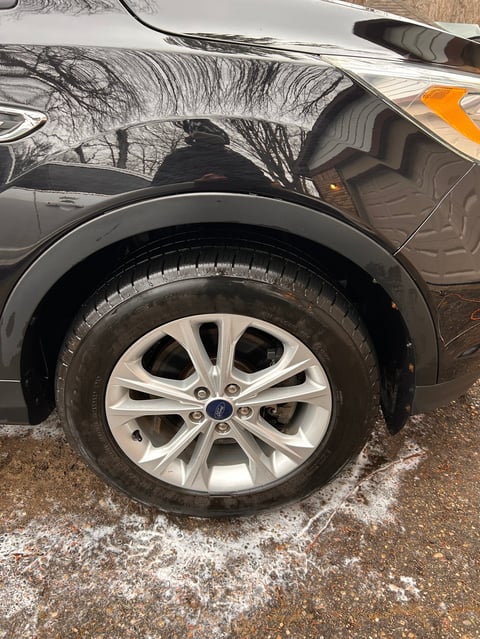 Clean Ford SUV wheel with white alloy rim