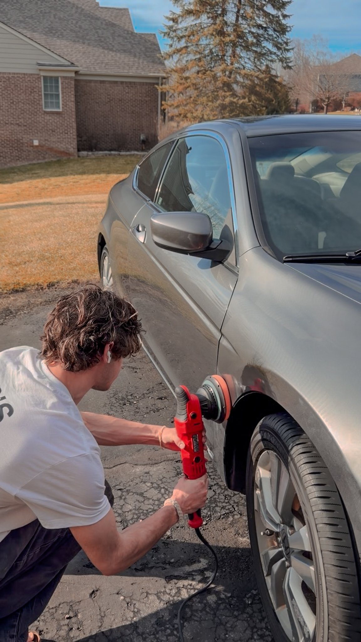 JP performing paint correction on a vehicle