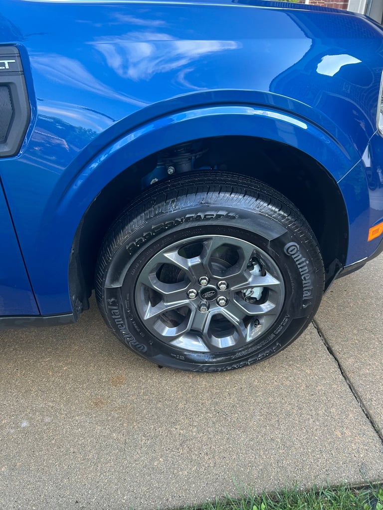 Bright blue SUV wheel with chrome rim