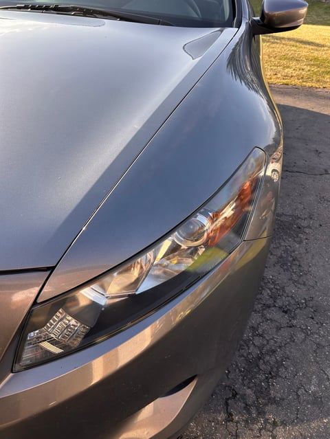 Restored silver sedan hood and LED headlight